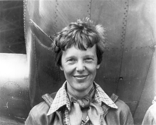 Amelia Earhart beside her plane