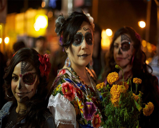 Women with calaveras makeup celebrating Día de Muertos in the Mission District of San Francisco, California
