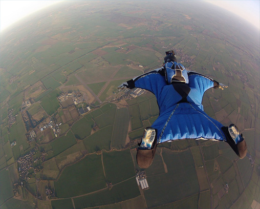 Wingsuit flyer over fields in the UK