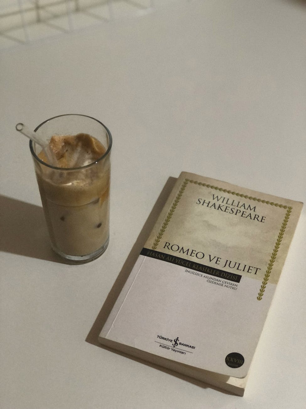 a glass of iced coffee beside a book