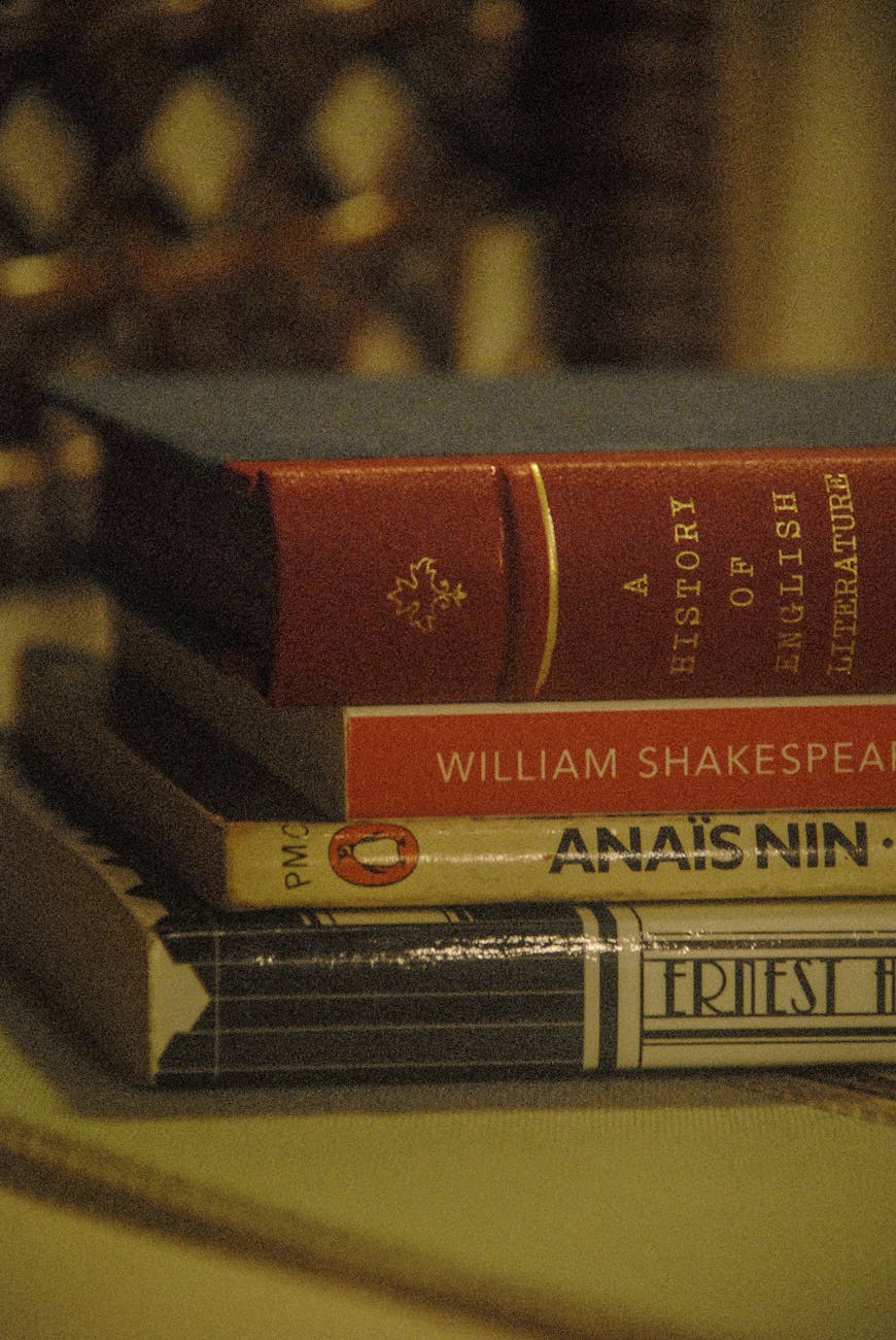 close up of a pile of books on a desk