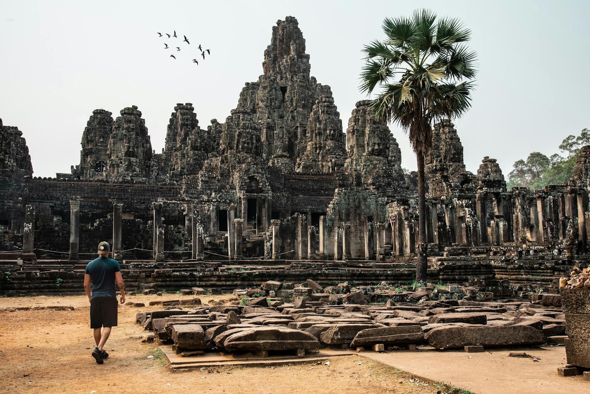 man looking at an ancient temple