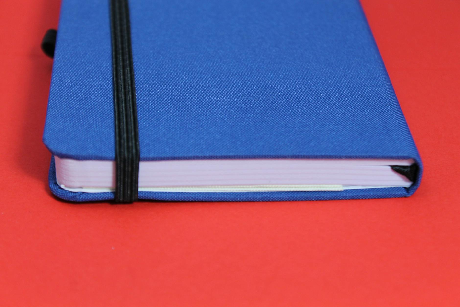 blue notebook on red surface