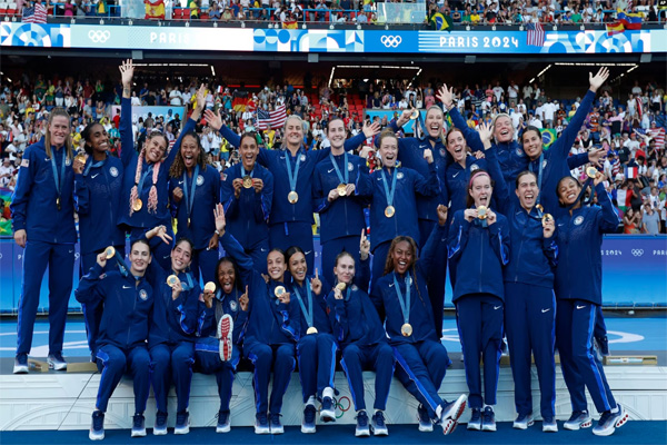 United States team players celebrate with their gold medals