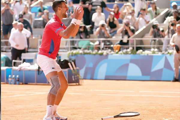 Novak Djokovic of Serbia celebrates after winning gold